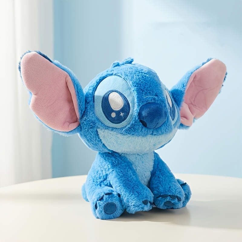 Blue starry-eye Stitch plush sitting in a light-filled room